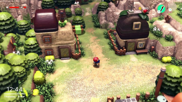 Un pequeño personaje recorre un pueblo de casas de piedra y árboles en Littlelands